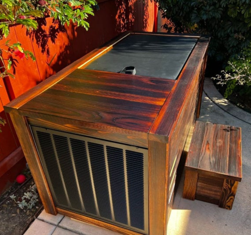 Wooden cold plunge with a lid on a patio
